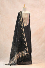 Black saree with gold embroidery on a mannequin against a beige background