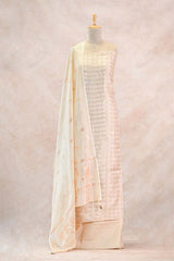 Mannequin wearing a cream-colored saree with a subtle pattern on a light pink background