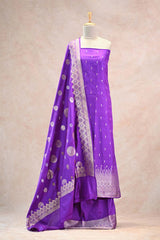 Purple saree with white patterns on a mannequin against a beige background