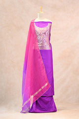 Close up of gold zari floral jaal weaving on the neckline of a purple Katan silk suit set with a shaded organza hand-embroidered dupatta.