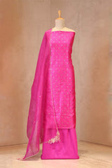 Pink saree with a matching blouse on a mannequin against a beige background