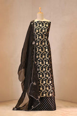 Black and gold traditional outfit on a mannequin against a neutral background