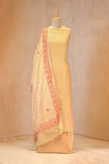 Yellow suit set with a pink border on a mannequin against a plain background