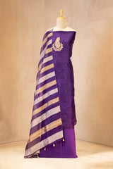 Purple saree with gold stripes on a mannequin against a beige background