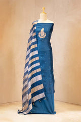 Blue saree with white and gold stripes on a mannequin against a beige background