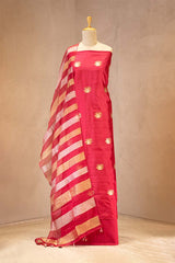 Red suit set with gold patterns on a mannequin against a beige background