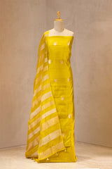 lime yellow suit set with white patterns on a mannequin against a neutral background