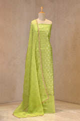 Gold zari woven ethnic buti and on Lime Green Chiniya silk unstitched suit set with an embroidered organza dupatta.