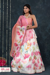 Woman wearing a floral saree with a dark background