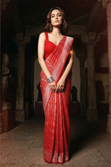 Woman in a Red Crepe saree standing in an ancient temple setting, Free Shipping Availble