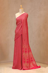 Close up of Pink Crepe Banarasi Khaddi Silk Saree showing gold zari geometrical patterns on the body and antique zari details on the pallu.