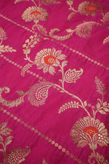 Close-up of pink Banarasi silk fabric with gold floral embroidery woven and orange accents