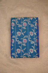 Blue Banarasi fabric with golden zari floral embroidery woven work on beige background