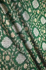 Green Banarasi silk fabric with intricate gold and silver floral pattern