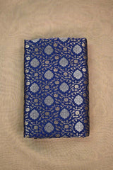 blue Banarasi silk fabric with floral zari woven pattern o beige background