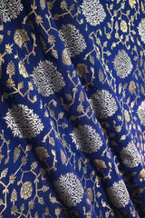 Close-up of blue Banarasi silk fabric with floral zari woven pattern