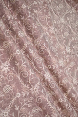 Floral and paisley patterned fabric with a soft mauve background