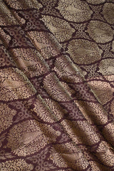 Close-up of a brown banarasi silk fabric with intricate floral brocade pattern