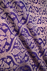 Close-up of a purple Banarasi silk fabric with a subtle floral pattern