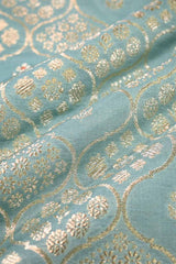 Close-up of a textured fabric with gold patterns on a blue background