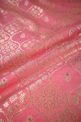 Close-up of pink fabric with gold intricate patterns