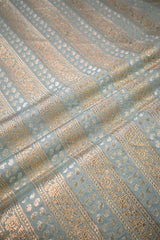Close-up of patterned fabric with gold and blue design