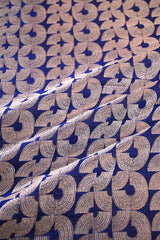 Patterned fabric with interlocking shapes on a blue background