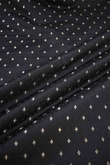 Close-up of black fabric with small white cross patterns