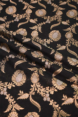 Decorative fabric with gold floral pattern on black background
