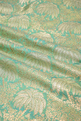 Gold palm leaf pattern on a teal background
