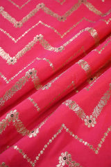 Pink fabric with gold geometric pattern