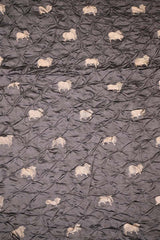 Close-up of grey Bandhani fabric with Pichwai motifs.