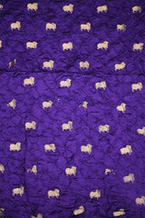 Close-up of Purple Bandhani fabric with Pichwai motifs.