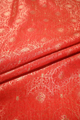 Red fabric with intricate white patterns
