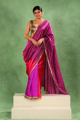 Women wearing of Purple and Pink Shaded Dupion Silk Wedding Wear Saree showing gold zari floral butis and handcrafted lace border.