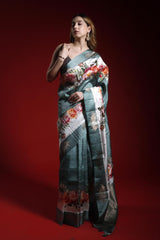 Woman wearing a floral saree against a red background