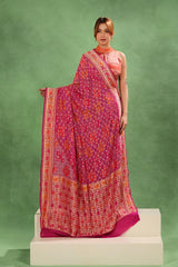Bride of Magenta Pink Georgette Bandhani Saree showing Paithani-inspired border and Gharchola pallu details.