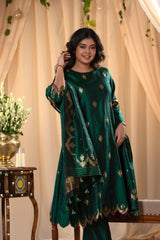 A woman in a traditional bottle green salwar suit and green banarasi dupatta