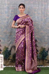 Woman wearing a purple and brown saree with a scenic background