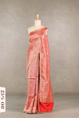 Red saree with gold patterns on a mannequin against a neutral background