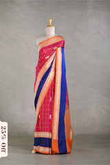 Saree with pink, orange, and blue pattern on a mannequin against a gray background