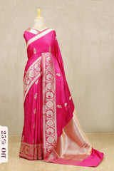 Pink saree with white patterns on a mannequin against a neutral background