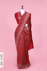 Red saree with white patterns on a pink background