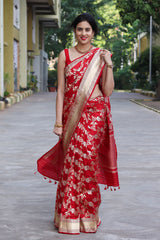 This Alkananda In Cherry Red Katan Silk Banarasi Saree is a wedding saree and festive wear saree. Free Shipping Available!