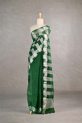 Green and white checkered organza silk tissue saree draped on a mannequin against a gray background