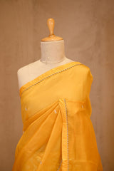 A yellow organza saree on dummy