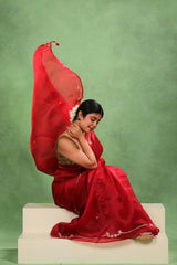 Bridal wearing Bridal Red Organza Silk Saree showing embellished floral buti and gota patti border with dual blouse options.