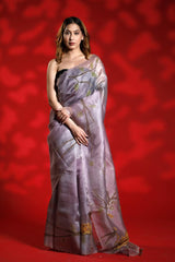 A woman wearing a lilac purple party wear saree with floral shikargah patterns on a red background