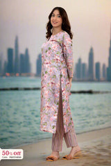 Woman in a floral dress standing by a waterfront with city skyline in the background