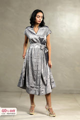 A woman wearing a silver party wear dress with promotional text of 50% off